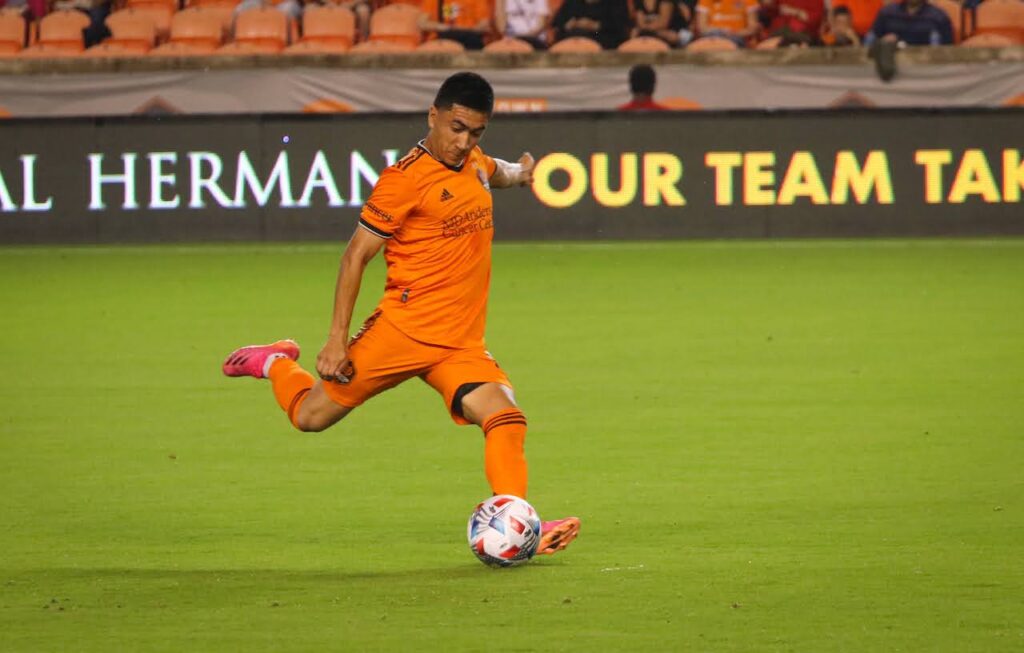 Memo Rodriguez kicks a ball