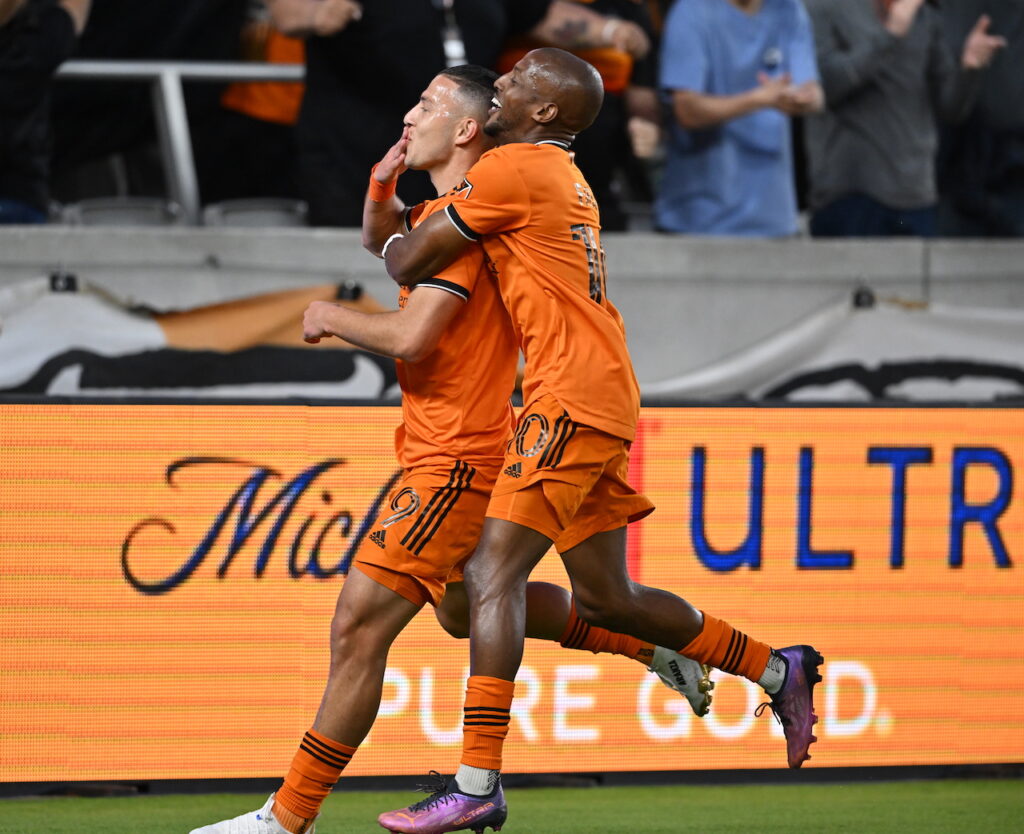 Houston Dynamo winger Fafa Picault hugs Dynamo forward Sebastian Ferreira after Ferrira's goal.